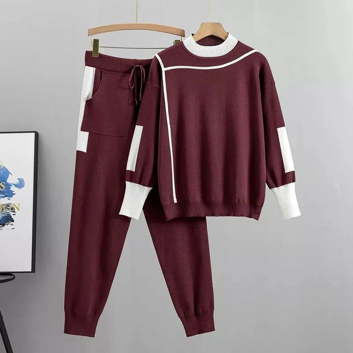 Woman wearing the Zoey luxury two-piece tracksuit set in burgundy with a relaxed, flattering fit
