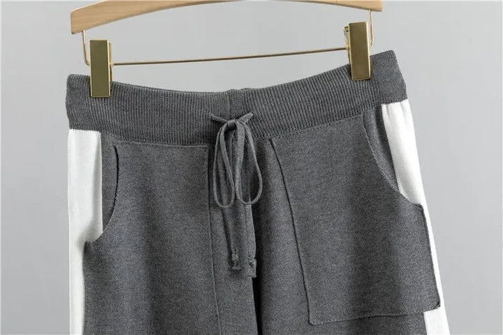 Full-length shot of the Zoey two-piece tracksuit in black showing pants length and overall silhouette