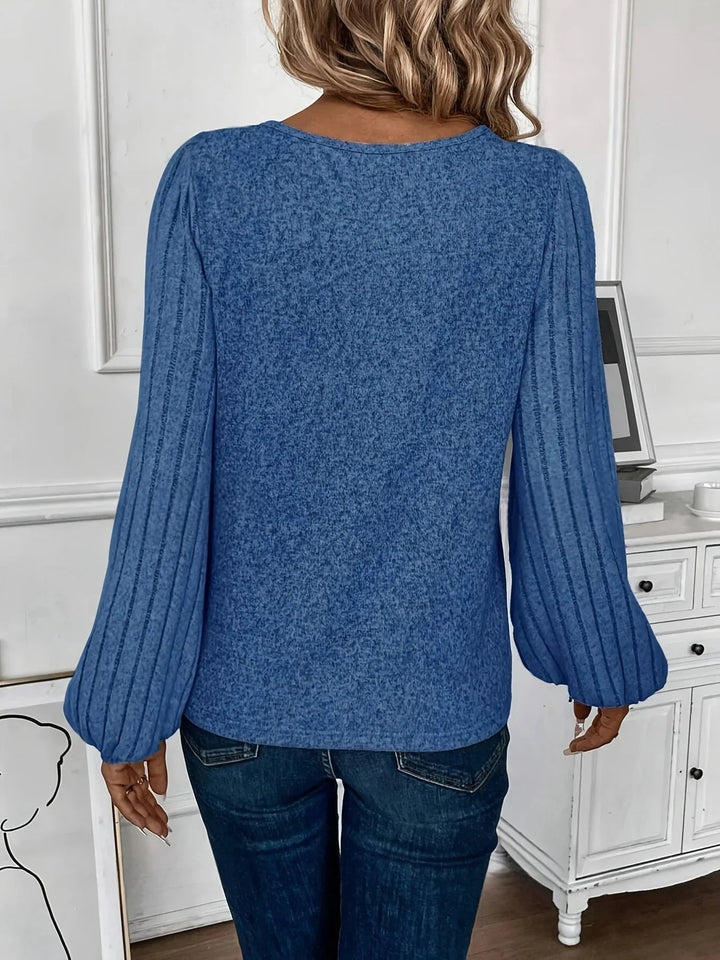 Overhead flat lay of the gray and blue lantern sleeve sweater options showing texture and color
