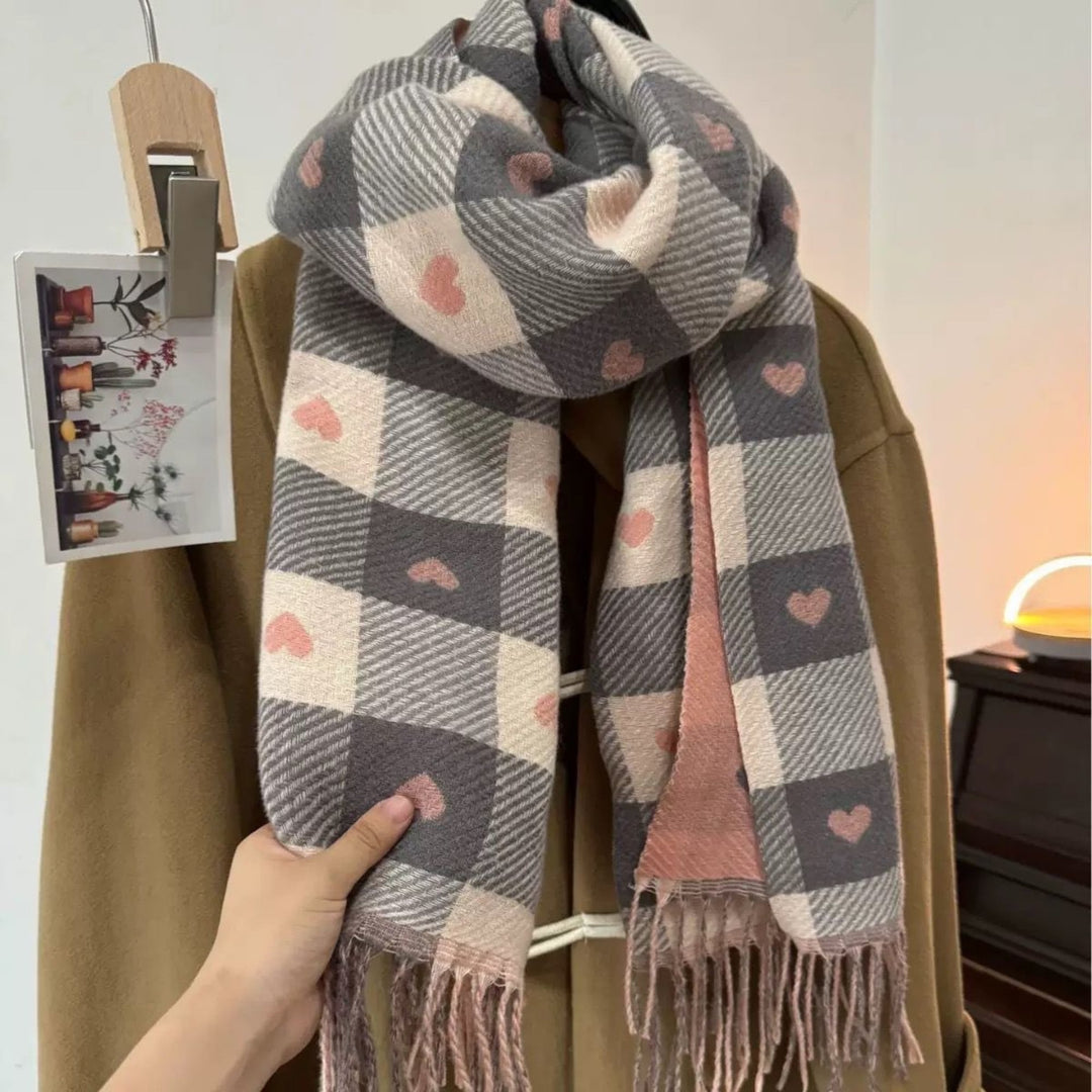 Model styling a Heart Pink plaid tassel scarf loosely wrapped around her neck